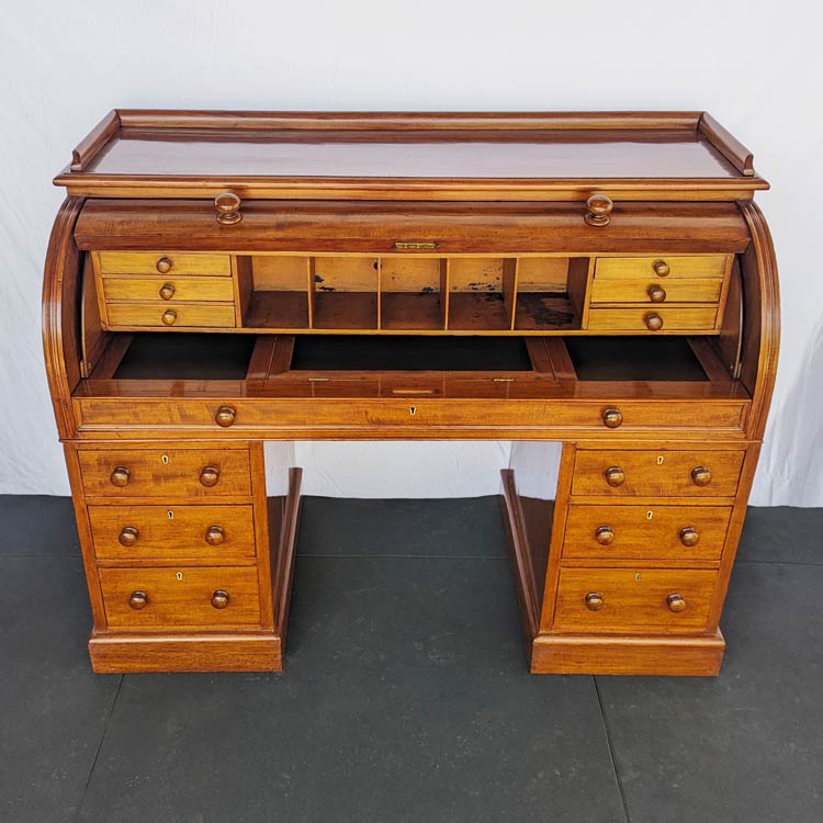 This desk was stripped and French polished. The drawers were repaired, and the writing surface replaced.