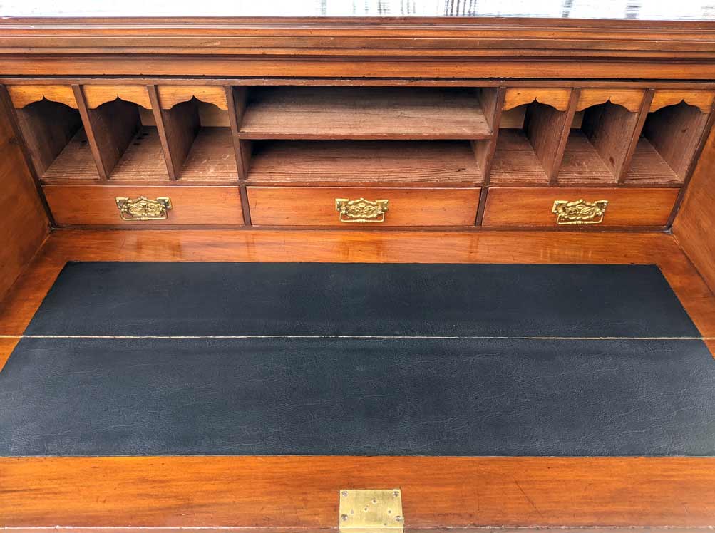 This drawer from an antique writer's desk/bookcase has been repaired and refinished. The brass hardware items were cleaned and the desk insert was replaced.