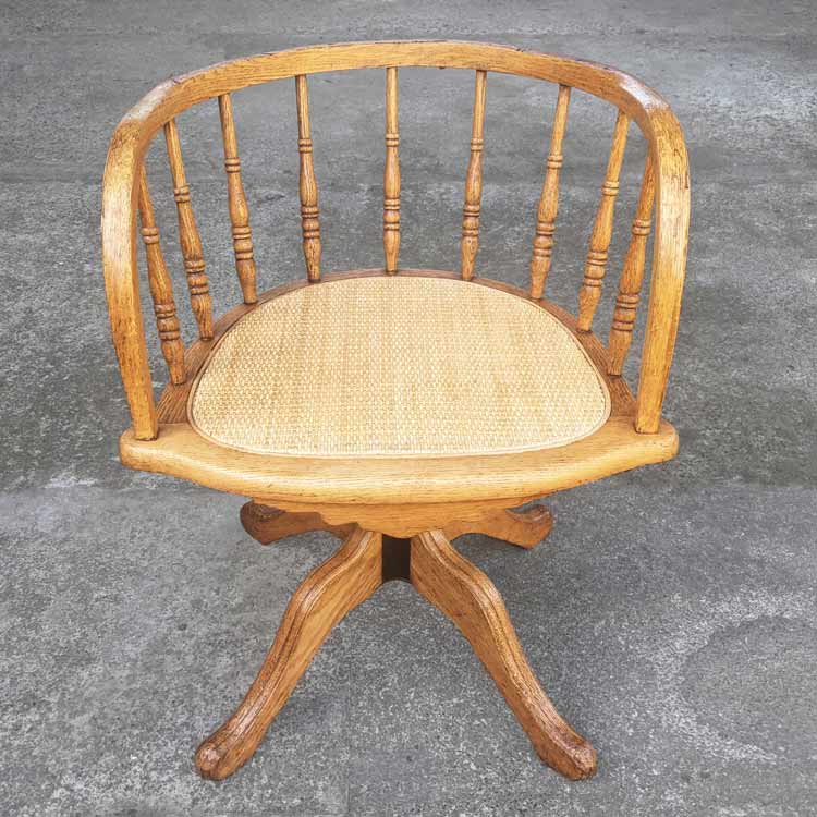 This chair was stripped and refinished, and the closed-weave rattan webbing was replaced